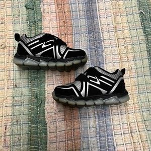 Toddler size 6 sneaker with 2 Velcro strap closure.  Black & silver